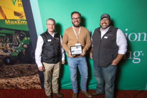 Justin Hiebert (center) of Hiebert Farms receiving the award from Doug Wright (left) and Matt Bennett (right) of Precision Planting